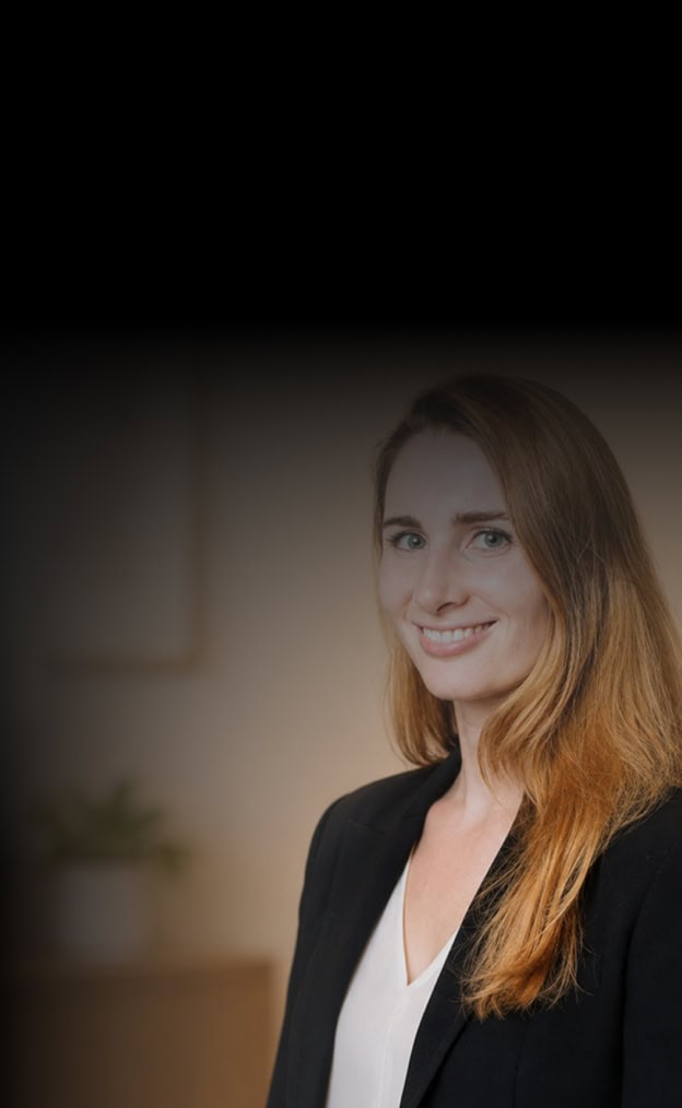 Confident woman with red hair in a business setting.