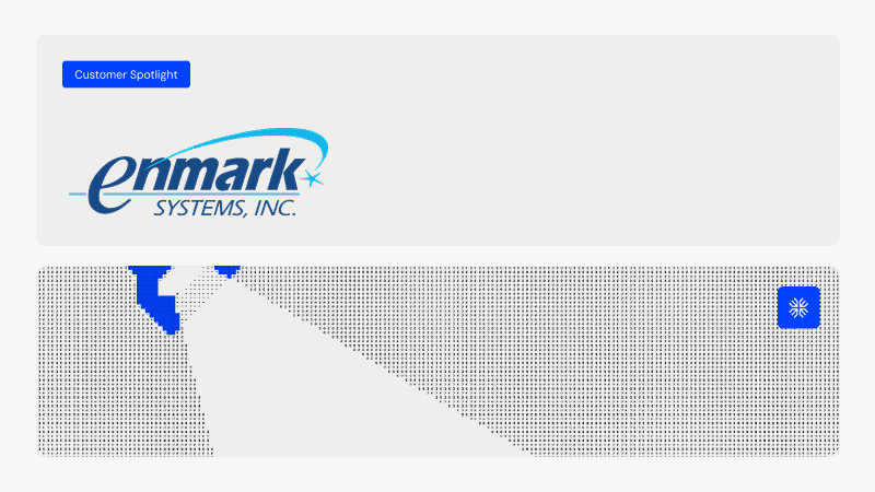 Enmark Systems logo displayed on a digital screen with a 'Customer Spotlight' badge.