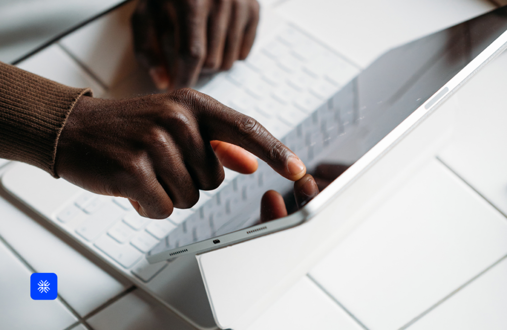 Hands using a tablet for subscription billing management.