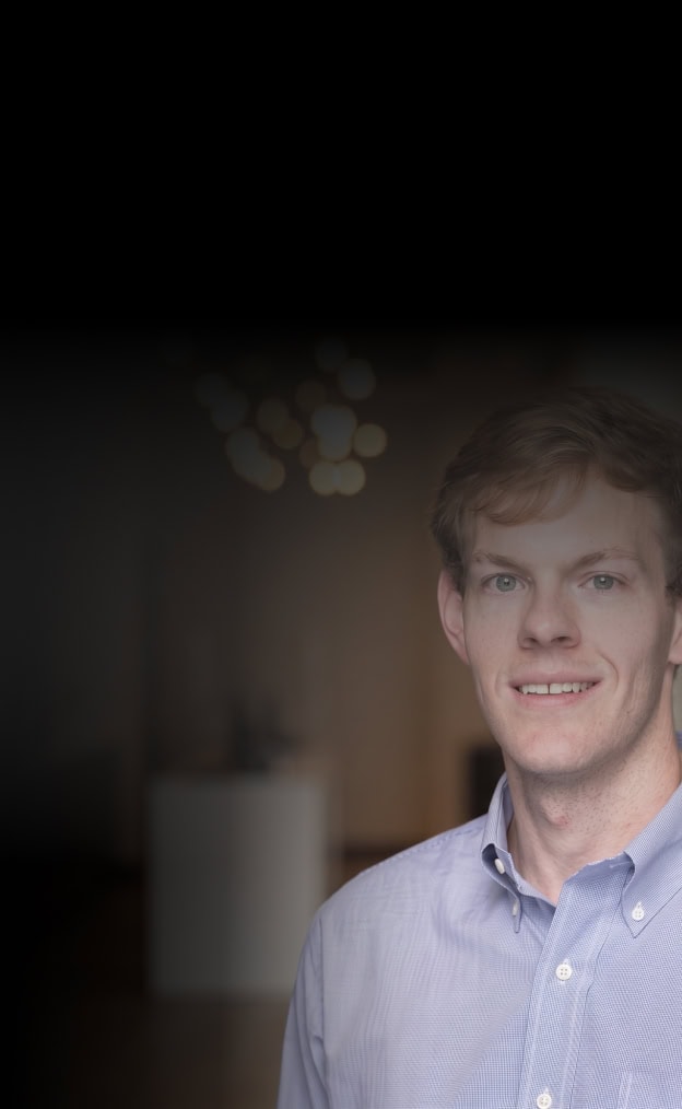 Young professional man in a modern office setting.
