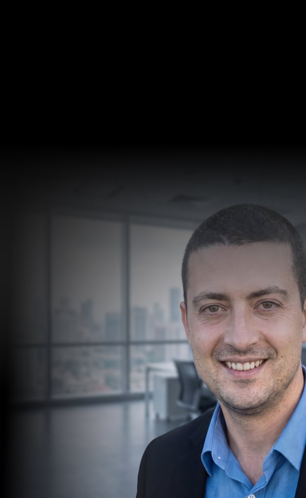 Business professional smiling in a modern office setting.