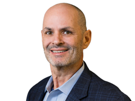 A man in a grey suit and blue inner shirt