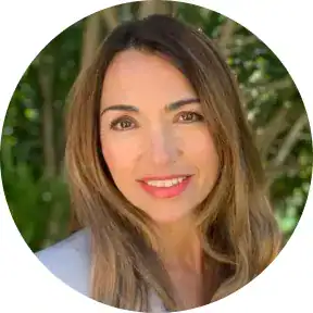 Professional woman smiling outdoors, representing Maxio's pricing solutions.