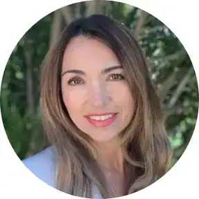 Professional woman smiling outdoors, representing Maxio CPQ solutions.