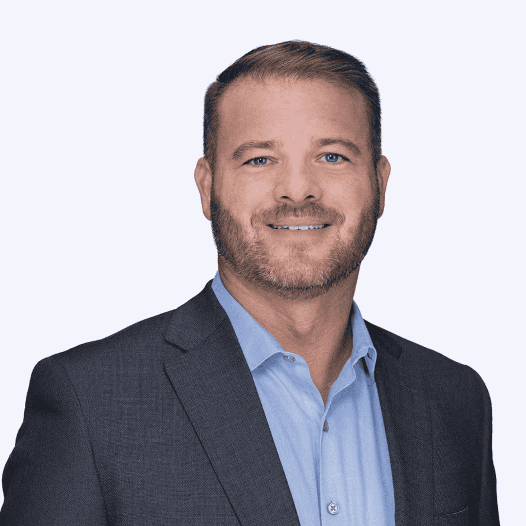 Professional man in a suit smiling for a corporate portrait.